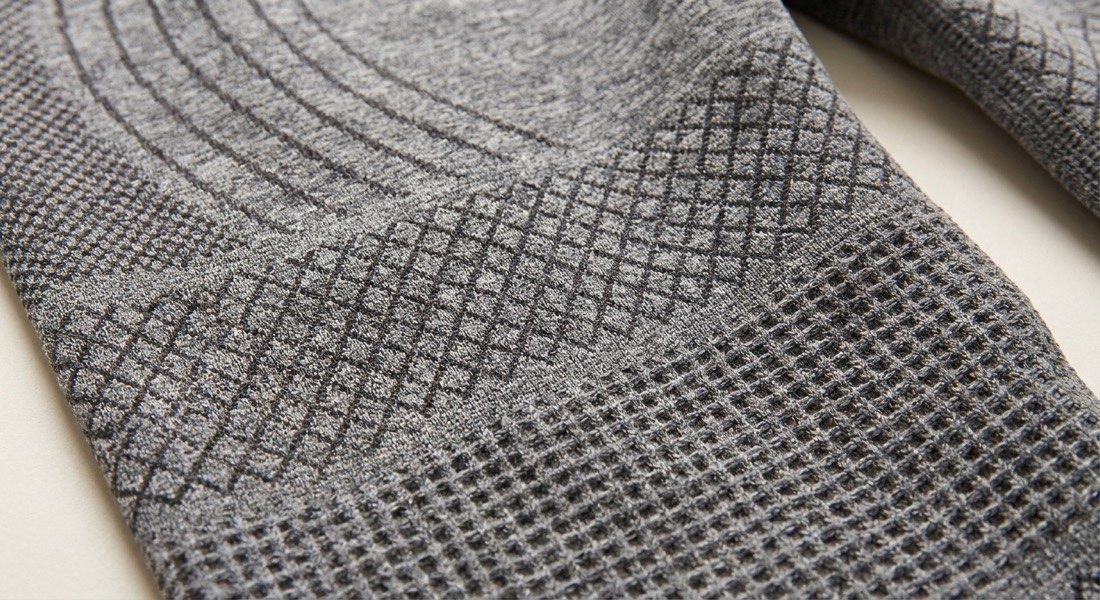 Pink high-waisted 3D compression leggings showing the raised knit texture up close